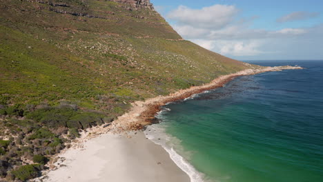 Scenic-View-Of-Sandy-beach-In-Llandudno,-Cape-Town-In-South-Africa-On-A-Sunny-Day---aerial-shot