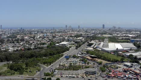 Juan-Pablo-Duarte-Highway-with-skyscrapers-and-sea-in-background,-Santo-Domingo-in-Dominican-Republic