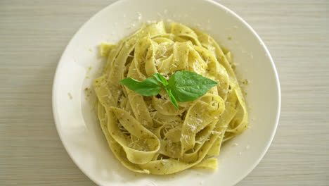 pesto-fettuccine-pasta-with-parmesan-cheese-on-top---Italian-food-style