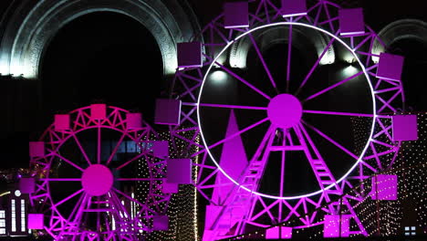 Purple-Lighted-Miniature-Ferris-Wheels-Rotating.-close-up