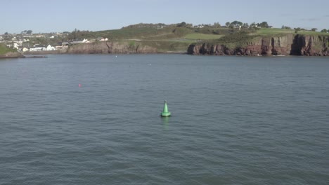 Green-navigational-buoy-marks-entrance-to-fishing-harbour-in-Ireland