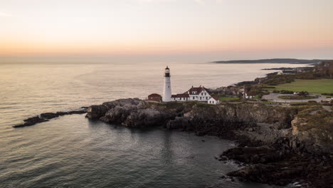 Scenic-Aerial-Timelapse-of-Portland-Head-Light,-Maine,-with-moving-water-and-beautiful-sunrise