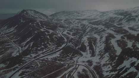 Dark-Winter-Scene-of-Snowy-Mountain-Roads-of-Iceland---Aerial