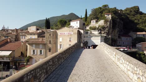 Walking-on-Historic-Bridge-of-Old-City-Next-to-River-in-the-Provence