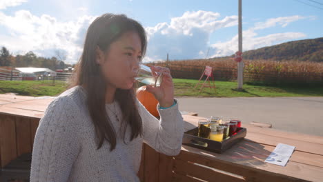 Attractive-young-Asian-woman-drinking-hard-cider