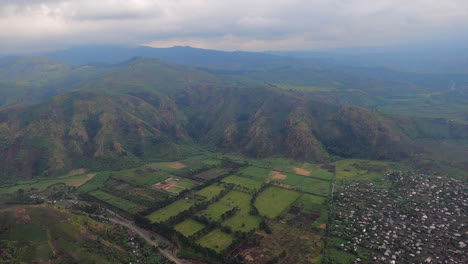 Overcast-flight-leaves-Sake,-Congo-over-rolling-Rift-Valley-mountains