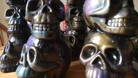 Multicoloured-painted-ceramic-spooky-death-skull-totem-crafts-pottery-ornament-closeup-dolly-left