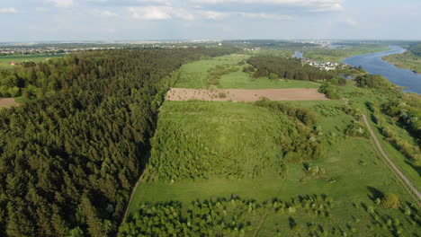 Lithuanian-landscape-with-forest,-meadows-and-river,-aerial-drone-view