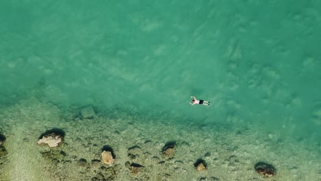 Aerial-View-of-Tourist-Snorkeling-at-Adriatic-Sea,-Betina,-Murter-Island,-Croatia