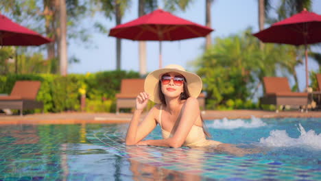 Petite-Sexy-Asian-Female-in-Swimming-Pool-Enjoying-on-Hot-Summer-Day,-Full-Frame