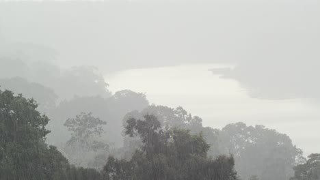 Heavy-rainfall-in-tropical-rainforest,-elevated-view-over-Tambopata-River