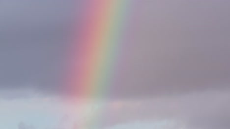 Closeup-Rainbow-Down-Tilt-view-to-the-Blue-clouds-just-after-rain