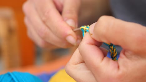 Making-Bracelet---Woman's-Hand-Knitting-Blue-And-Yellow-Yarn,-Colors-Of-Ukrainian-Flag