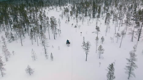 A-Group-Of-People-Riding-Their-Snowmobiles-During-Winter-In-Muonio,-Finland--Aerial