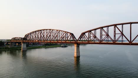 Aerial-view-close-to-the-Big-Four-bridge,-sunset-in-Louisville,-USA---pan,-drone-shot