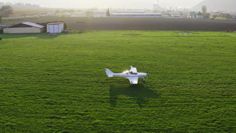 A-Single-Engine-White-Plane-Moving-Through-The-Meadow-In-Slovakia