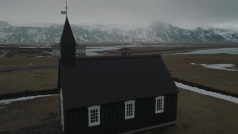 Aerial-Approach-of-Black-Church-of-Budir-Religious-Building-in-Iceland