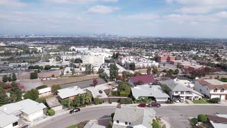 City-of-Los-Angeles,-over-urban-homes-in-Baldwin-Hills-area,-downtown-in-a-distance