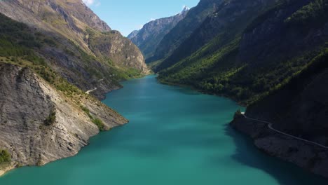 Drone-footage-of-mountain-lake-pristine-clear-calm-blue-water,-unpolluted-unexplored-area-of-mother-earth