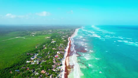 Vibrant-Tropical-Caribbean-Coastline-With-Turquoise-Blue-Water-And-Lush-Green-Foliage-In-Tulum-Mexico