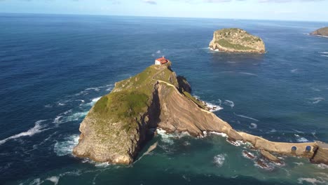 Little-islet-hermitage-chapel-on-isolated-cliff-over-the-ocean-aerial-view