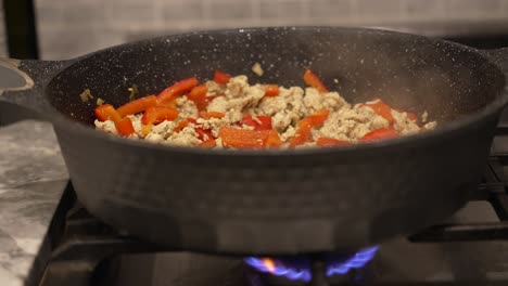 Steam-rising-from-sausage-and-red-peppers-cooking-on-a-stove