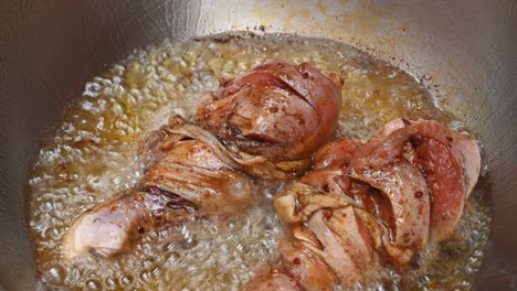 Showing-signs-that-the-underpart-is-already-cooked-and-it-is-beginning-to-look-brown-on-their-sides,-ready-to-be-turned,-Frying-Chicken-Drumsticks-in-a-pan