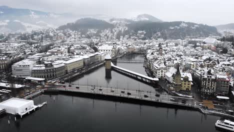 Aerial-view-of-Lucerne,-Switzerland-as-the-city-is-covered-in-snow-in-winter