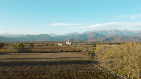 Iglesia-Alaverdi-Y-Las-Tierras-De-Cultivo-Circundantes-Con-Cordillera-En-Kakheti,-Georgia