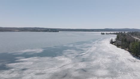 Ice-On-Frozen-Water-Of-Lake-Magog-Starting-To-Melt-On-A-Sunny-Day-In-Quebec,-Canada