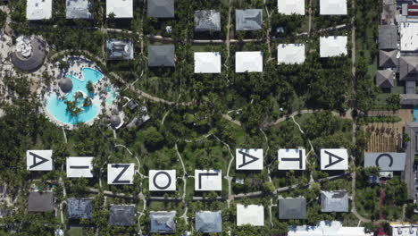 Large-letters-adorn-the-roofs-of-the-beautiful-Catalonia-Bavaro-Beach-Resort,-aerial-top-down