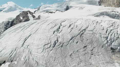 revealing-aerial-shot-of-ice-mountain-glacier-in-switzerland,-massive-mountain-aerial-view-of-beautiful-mountain-scenery