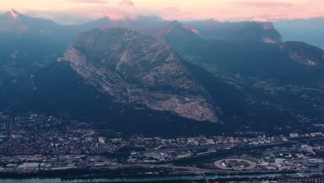 Grenoble-aerial-panoramic-of-city-and-alps-french-mountain-view-during-epic-cloudy-sunset