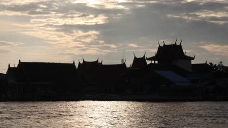 Silhouette-of-a-Temple-Across-the-River-of-Bang-Tabun-During-a-Morning-Sunrise-in-Thailand