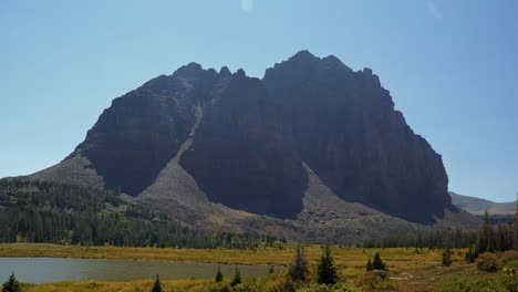Stunning-nature-landscape-tilting-down-shot-of-the-incredible-Red-Castle-Peak-up-a-backpacking-trail-in-the-High-Uinta-National-Forest-between-Utah-and-Wyoming-with-a-fishing-lake-to-the-left