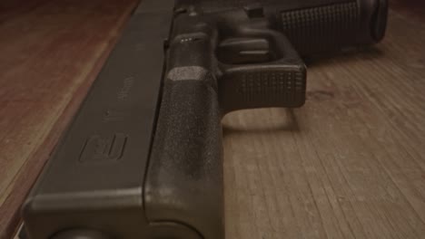 Stunning-macro-dolly-out-of-Glock-17-handgun-on-a-wooden-surface