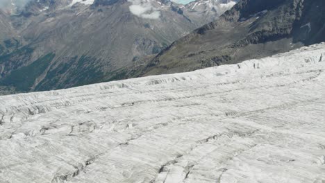 close-areial-fly-over-ice-glacier-with-deep-crevasses-and-cracks,-glacier-melting-concept-of-global-warming,-Aerial-fly-over-of-allalingletscher-switzerland