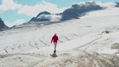 guy-person-walking-on-a-mountain-ridge-looking-into-beautiful-ice-glacier-mountain-scenery-in-saas-fee-switzerland,-sad-because-of-global-warming