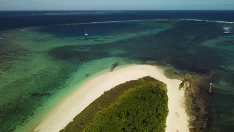 A-remote-island-part-of-the-archipelago-of-the-Isle-of-Pines-in-New-Caledonia---pull-back-aerial-view