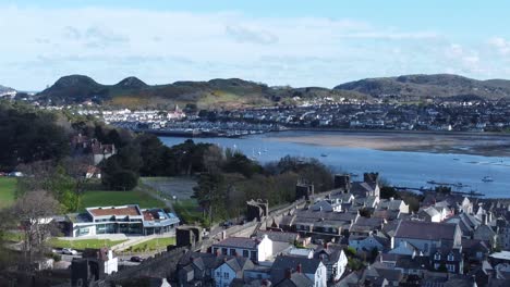 Welsh-holiday-cottages-enclosed-in-Conwy-castle-battlements-stone-walls-aerial-view-along-harbour
