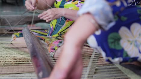 Two-women-handworking-on-sedge-mat-weaving-Vietnamese-traditional-craft