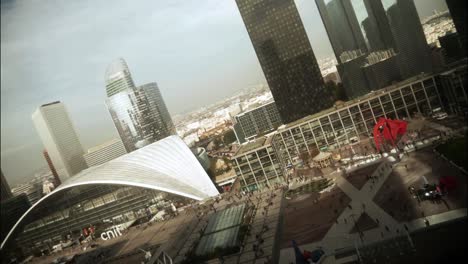 Time-lapse-view-from-above-of-the-Parvis-de-la-Défense-in-Paris,-with-the-crowd-and-a-carousel