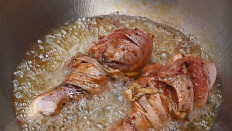 Two-pieces-of-Chicken-Drumstick-sizzling-in-a-hot-deep-oil-in-a-frying-pan
