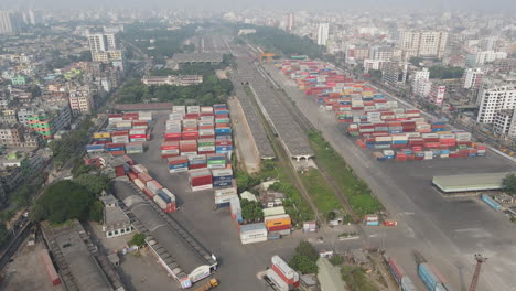 Huge-open-air-shipping-container-depot-in-the-middle-of-polluted-Dhaka-city,-Bangladesh-Day-Time