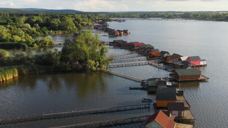 Stilt-village-in-Hungary-over-the-Bokodi-hutoto-lake,-aerial-drone-shot