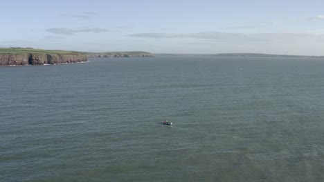 Sea-aerial:-Fisherman-in-open-boat-sets-lobster-traps-near-Irish-coast