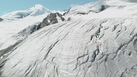 revealing-aerial-shot-of-ice-mountain-glacier-in-switzerland,-massive-mountain-aerial-view-of-beautiful-mountain-scenery
