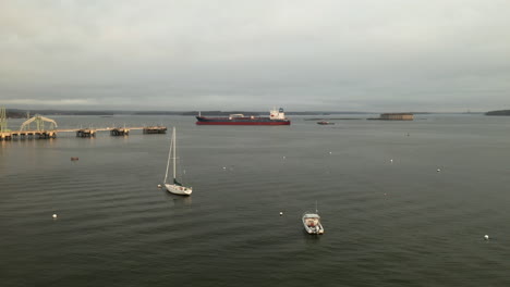 Stunning-aerial-view-of-a-large-shipping-boat-in-Casco-Bay-near-Fort-Georges,-Maine