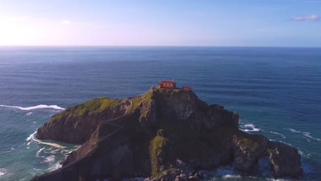 Aerial-view-of-Gaztelugatxe-is-islet-on-coast-of-Biscay-Spain-Basque-Country-it-is-connected-to-mainland-by-a-man-made-bridge-and-on-top-of-island-stands-a-hermitage