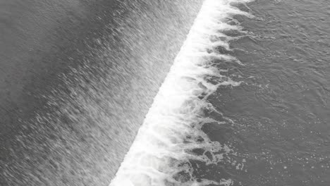 Abstract-view-of-weir-with-a-water-falling-down-and-making-foam
